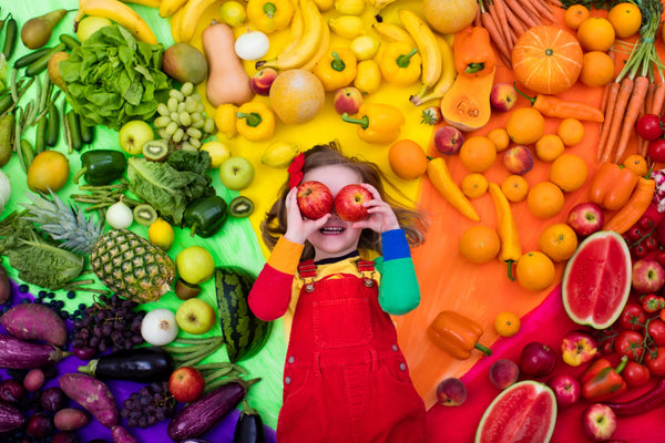 Girl with nutritious foods all around her