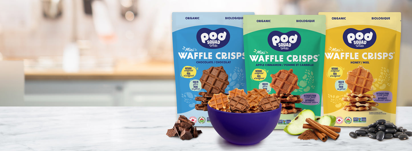 Three bags of Pod Squad Snacks Mini Waffle Crisps with a bowl of waffle crisps on a table.